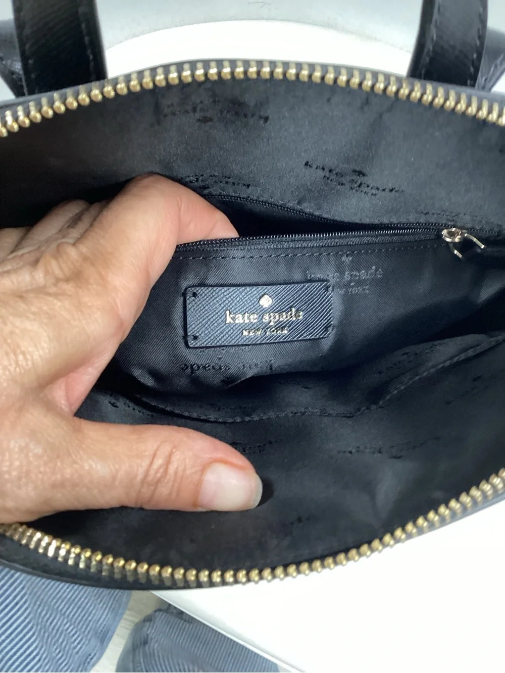 kate spade black leather backpack with gold logo